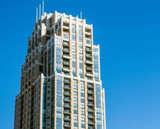 Residential tower with balconies against a blue sky